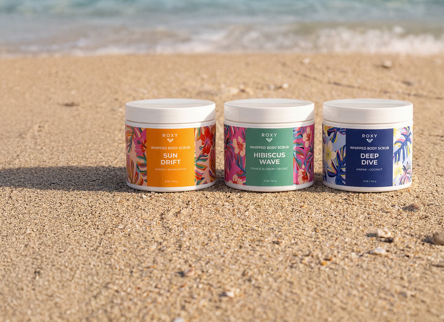Three Roxy®一分钟极速赛车168开奖结果记录体彩历史号码查询 body scrubs on a sandy beach with ocean waves in the background