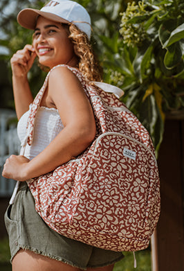 Woman wearing a patterned backpack outdoors