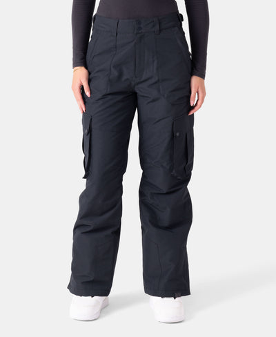 A person wearing black cargo pants with side pockets and white shoes, standing against a plain light background. Only the person’s lower body is visible.