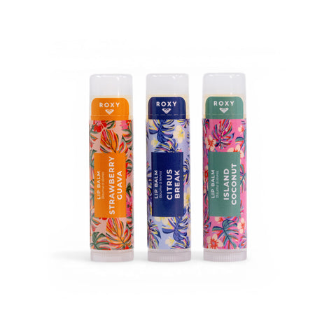 The Roxy Lip Balm Set features three vibrant tubes—Strawberry Guava, Citrus Break, and Island Coconut—each with colorful floral patterns and the Roxy logo, offering nourishing hydration in tropical flavors.