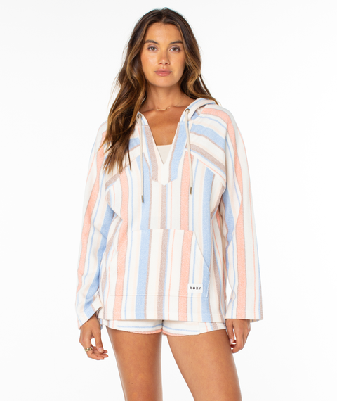 A woman faces forward in the Roxy Wild And Free Hoodie and matching shorts, featuring relaxed fit, summery pastel stripes, a front pocket, and breezy coastal vibes. The background is plain white.